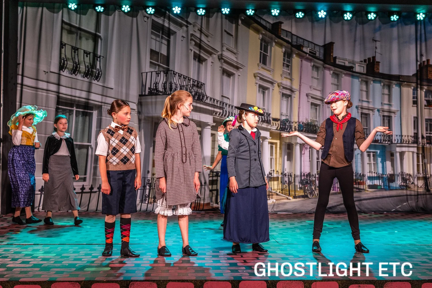 A cast performs in front of a London street set